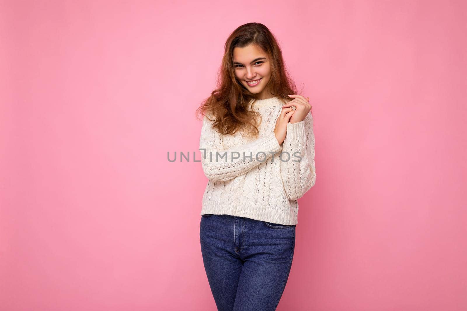 Portrait of positive cheerful fashionable woman in formalwear looking at camera isolated on pink background with copy space.