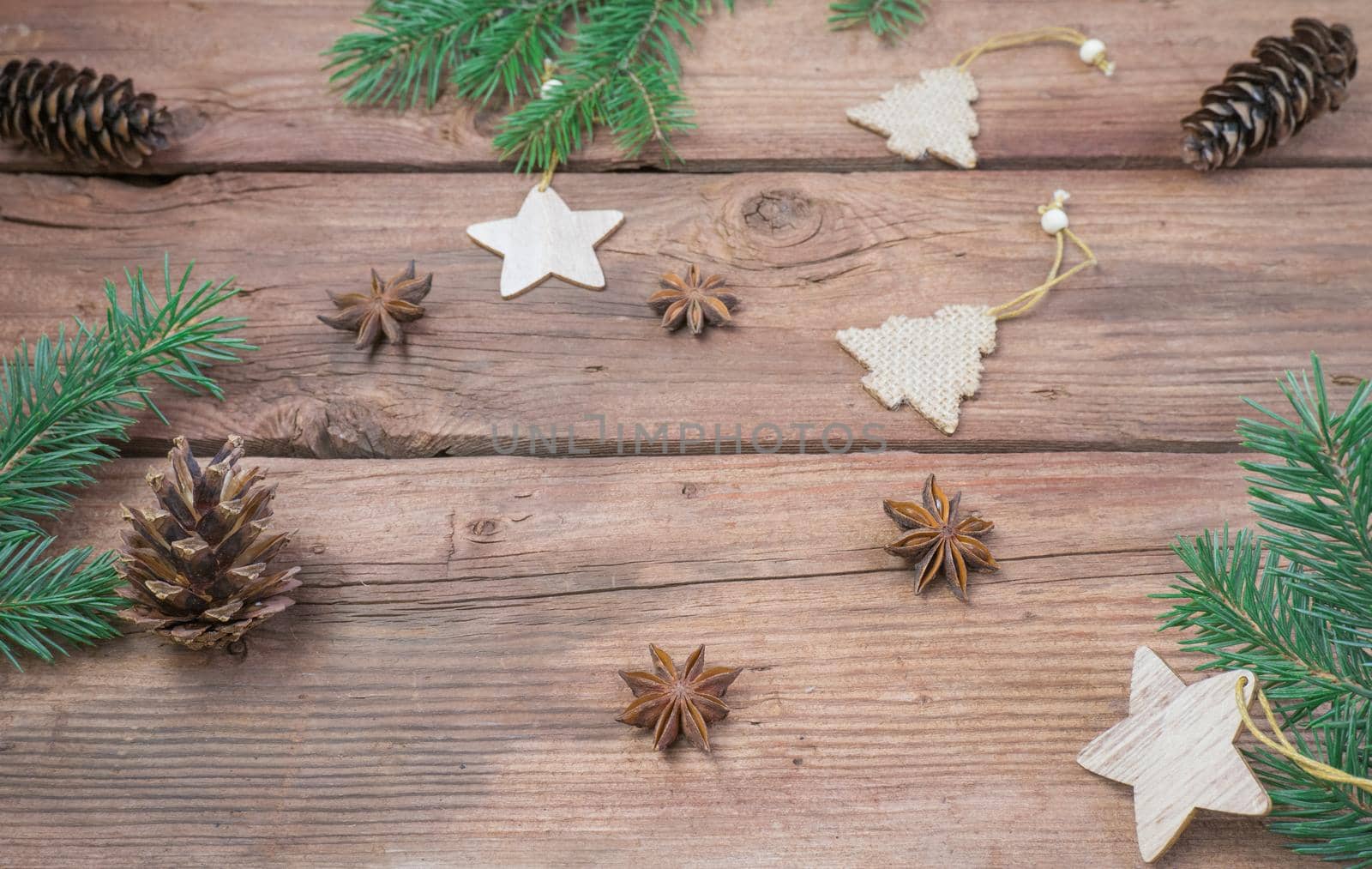 Top view of fir branch and cones on brown rustic table. Winter frame with coniferous branches. by Ekaterina34