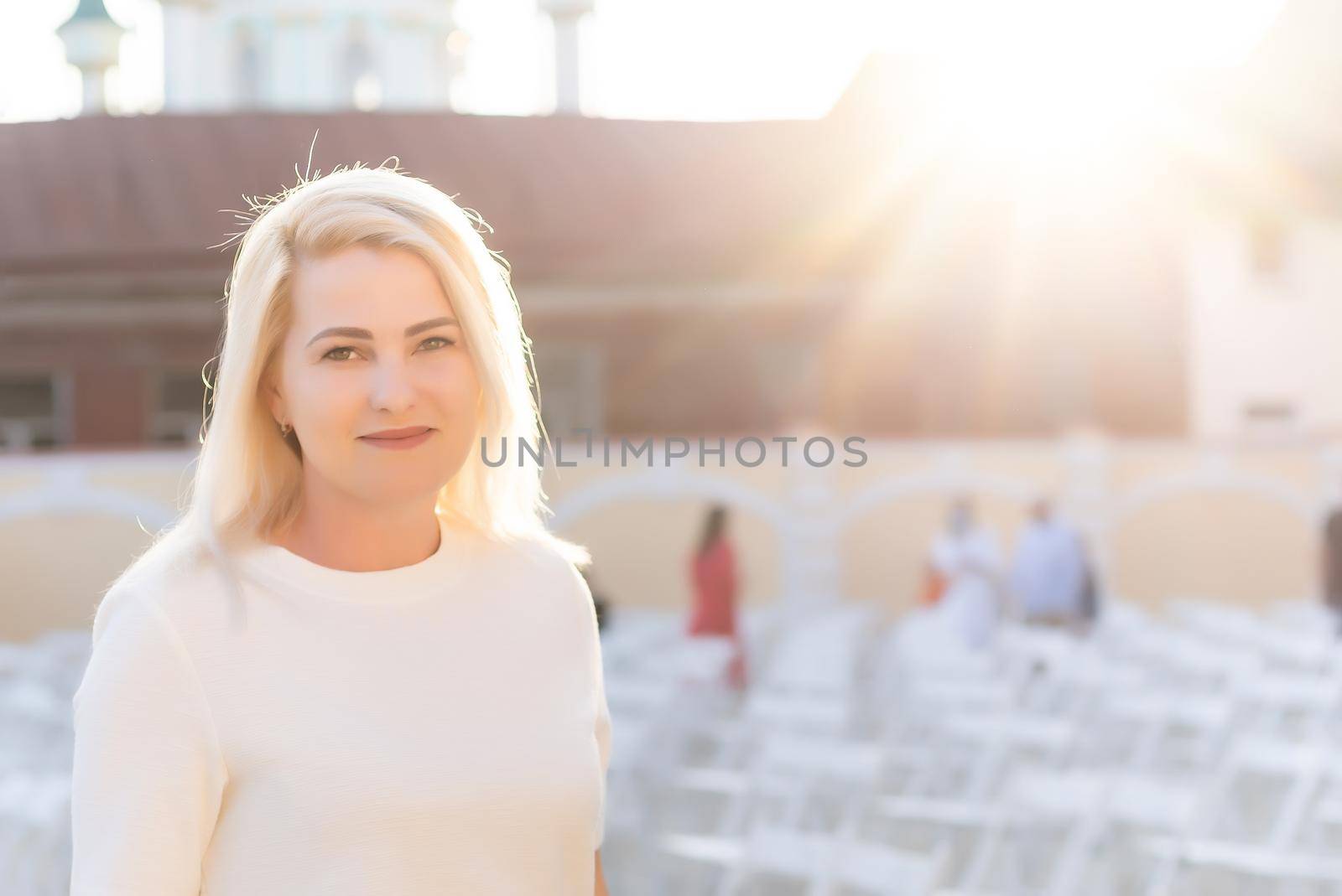 an empty concert hall, woman near empty chairs at concert