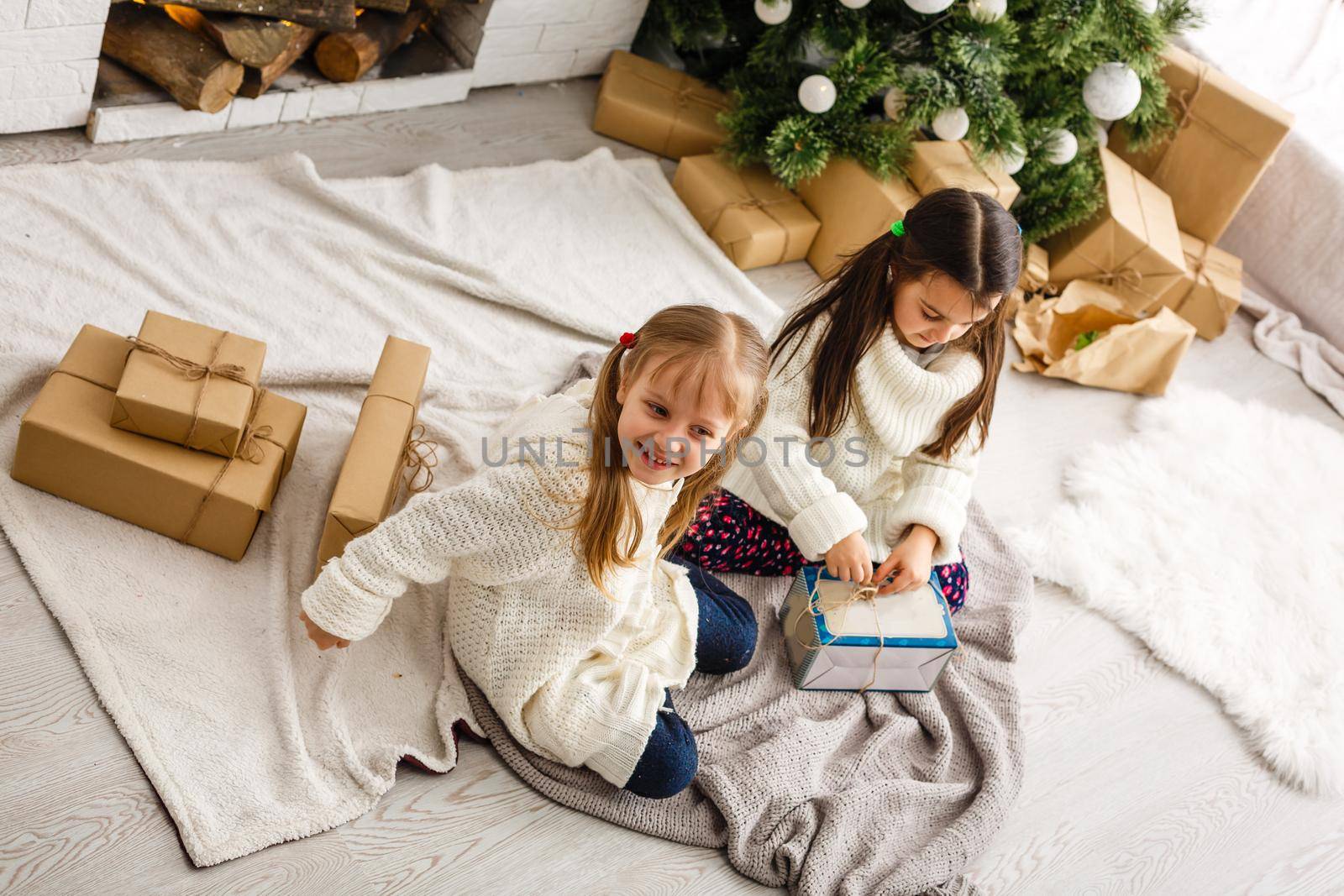 christmas, x-mas, winter, happiness concept - two adorable girls playing by Andelov13