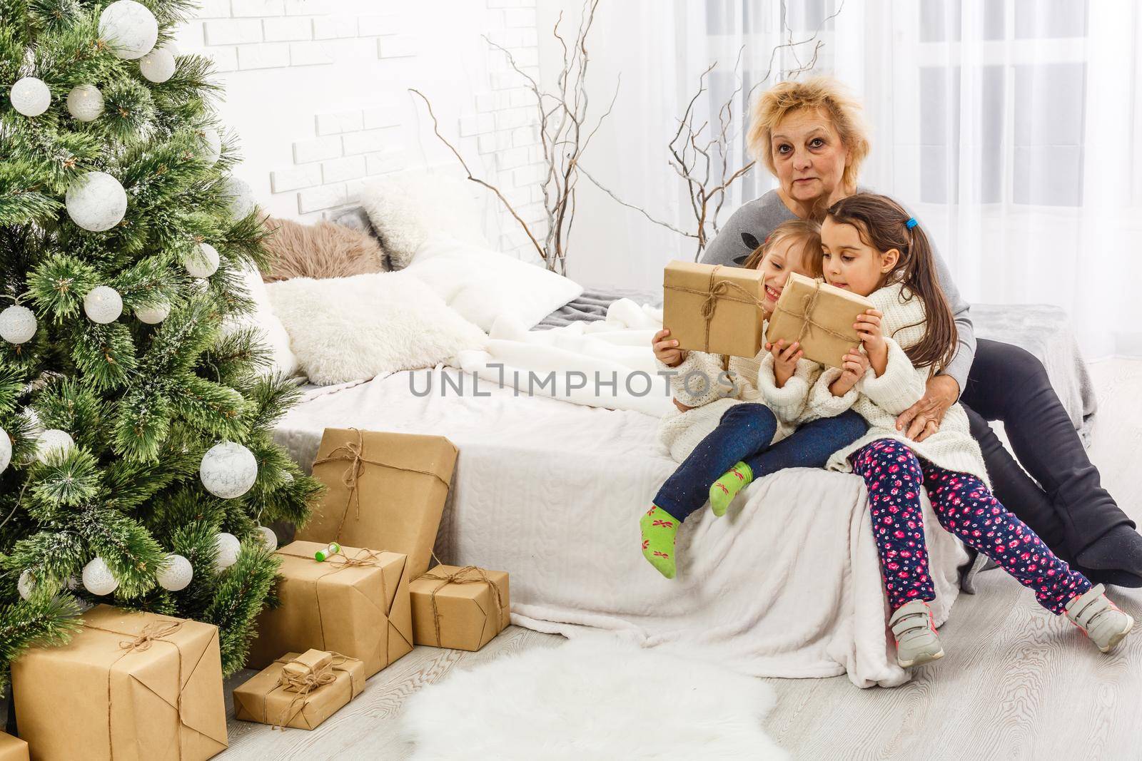 Merry Christmas and Happy Holidays. Grandma and children. The morning Xmas. Portrait loving family by Andelov13