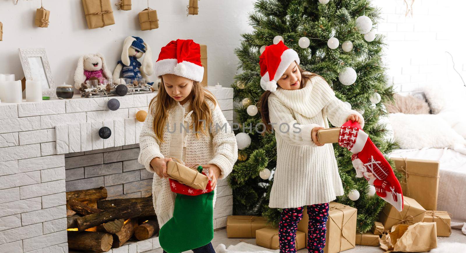 christmas, x-mas, winter, happiness concept - two adorable girls playing.