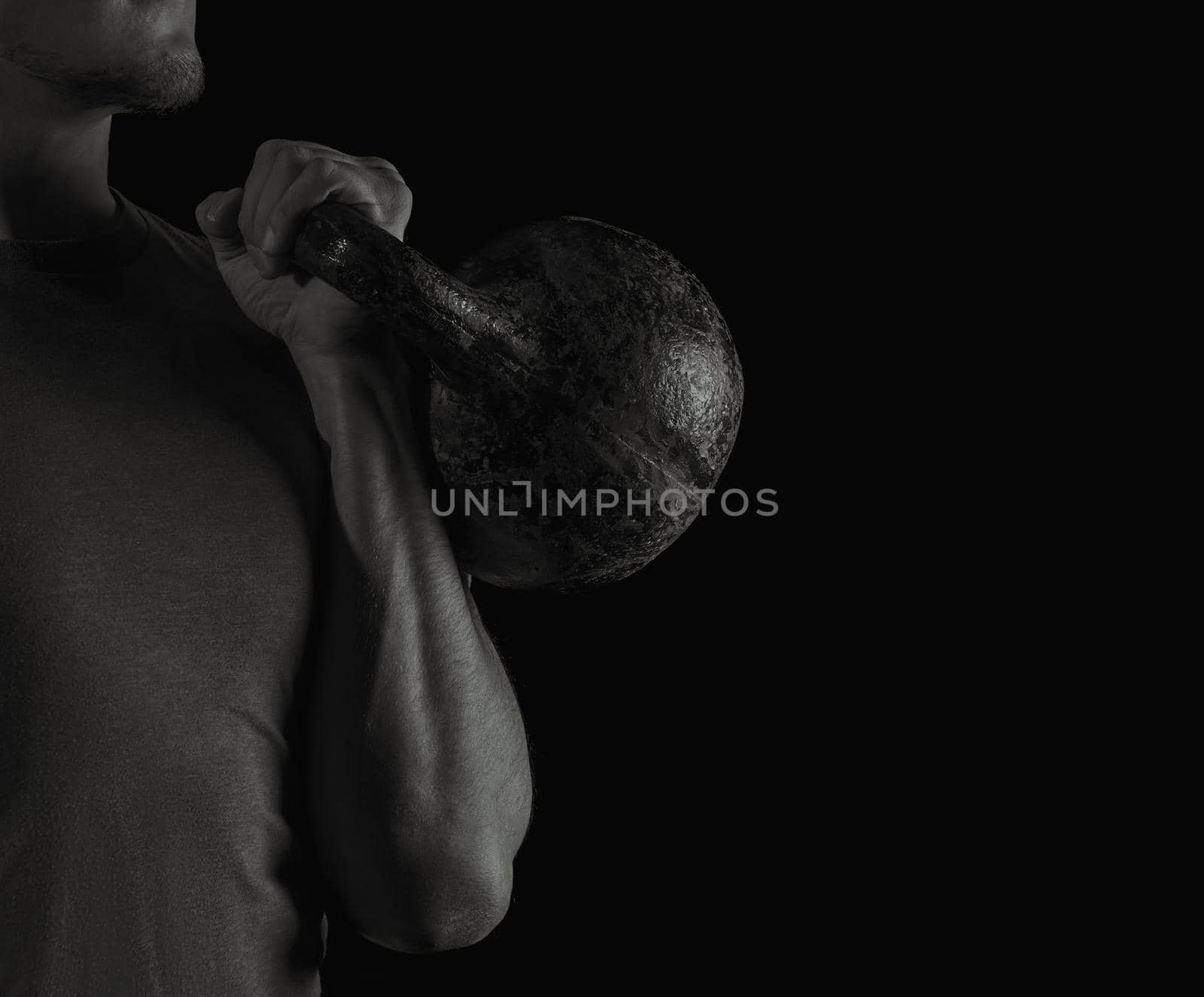 Man exercising with kettlebell by alexAleksei