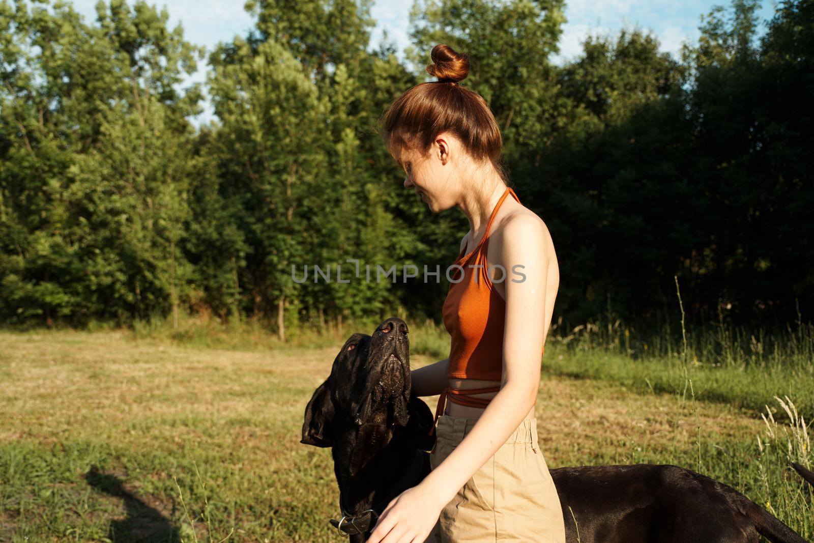 Cheerful Woman and a dog in the nature games Friendship by Vichizh