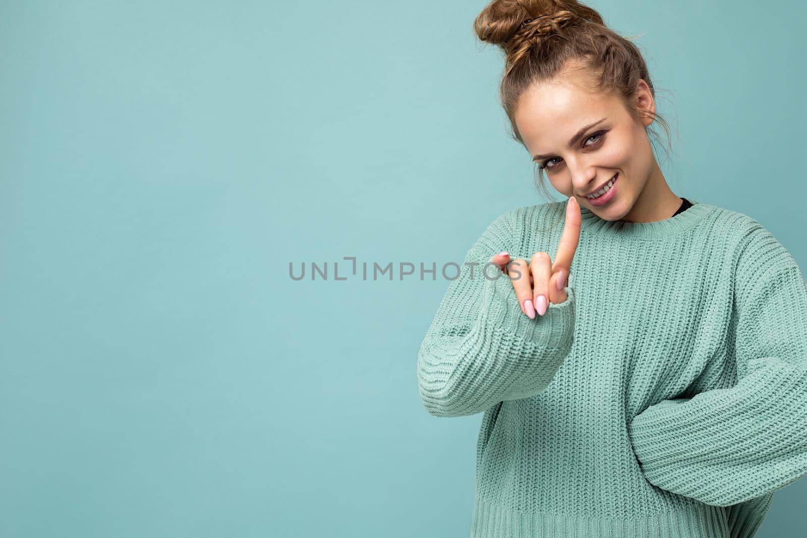 Photo of young positive happy smiling beautiful woman with sincere emotions wearing stylish clothes isolated over background with copy space and paying attention by TRMK