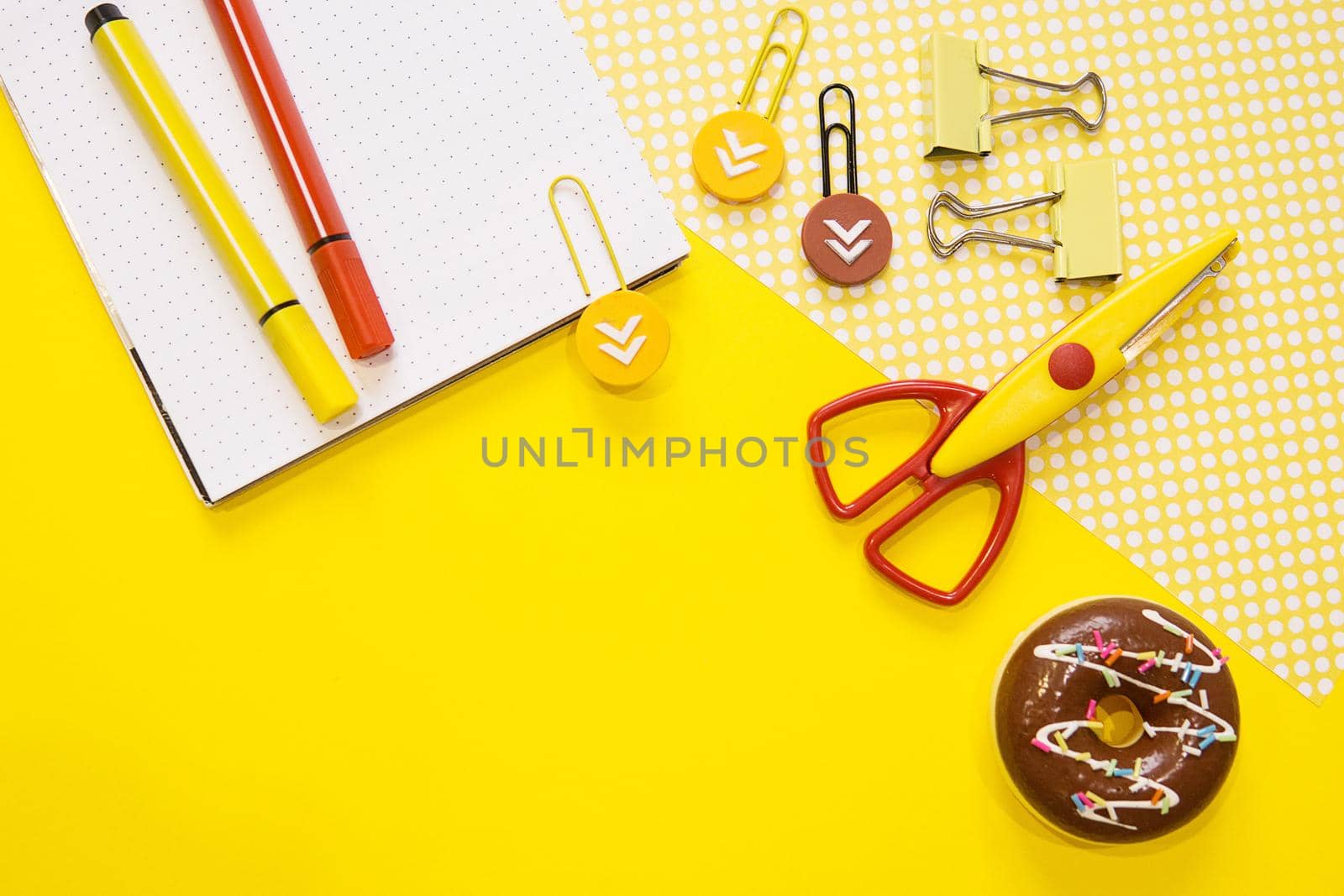 School supplies. Yellow and red colors. Flat lay composition. Yellow background. Space for text. Back to school.