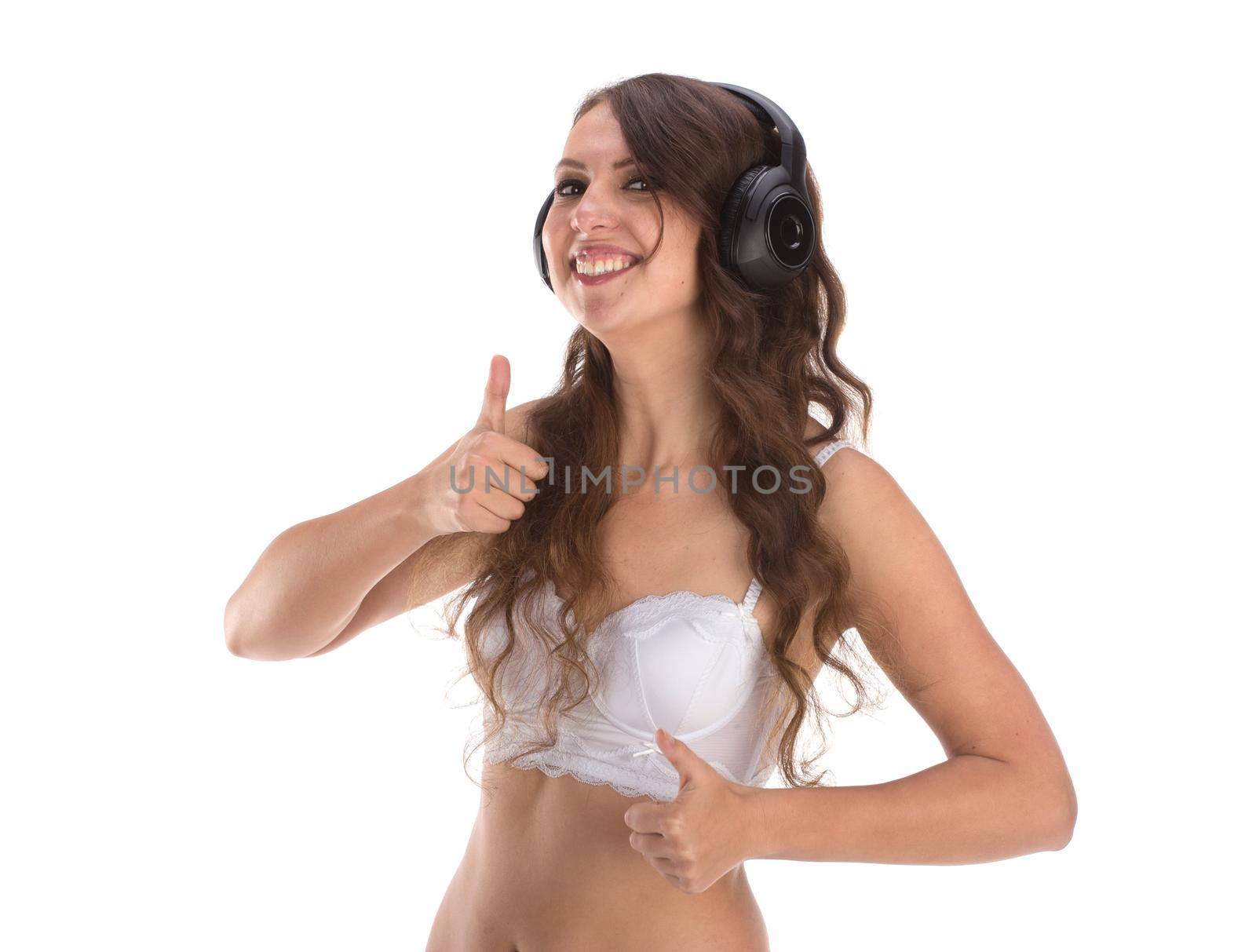 Attractive Sexy woman with beautiful body posing with headphones, isolated on white.