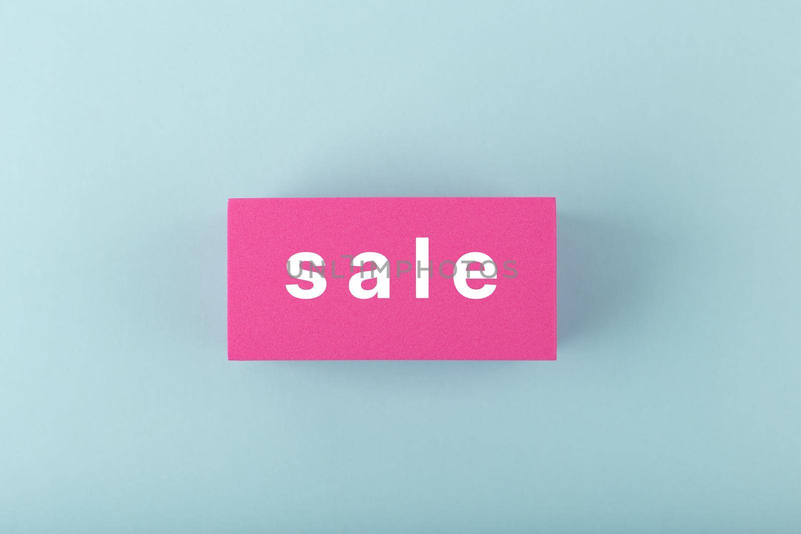 Sale minimal concept. Sale single word on pink rectangle against bright cold blue background by Senorina_Irina