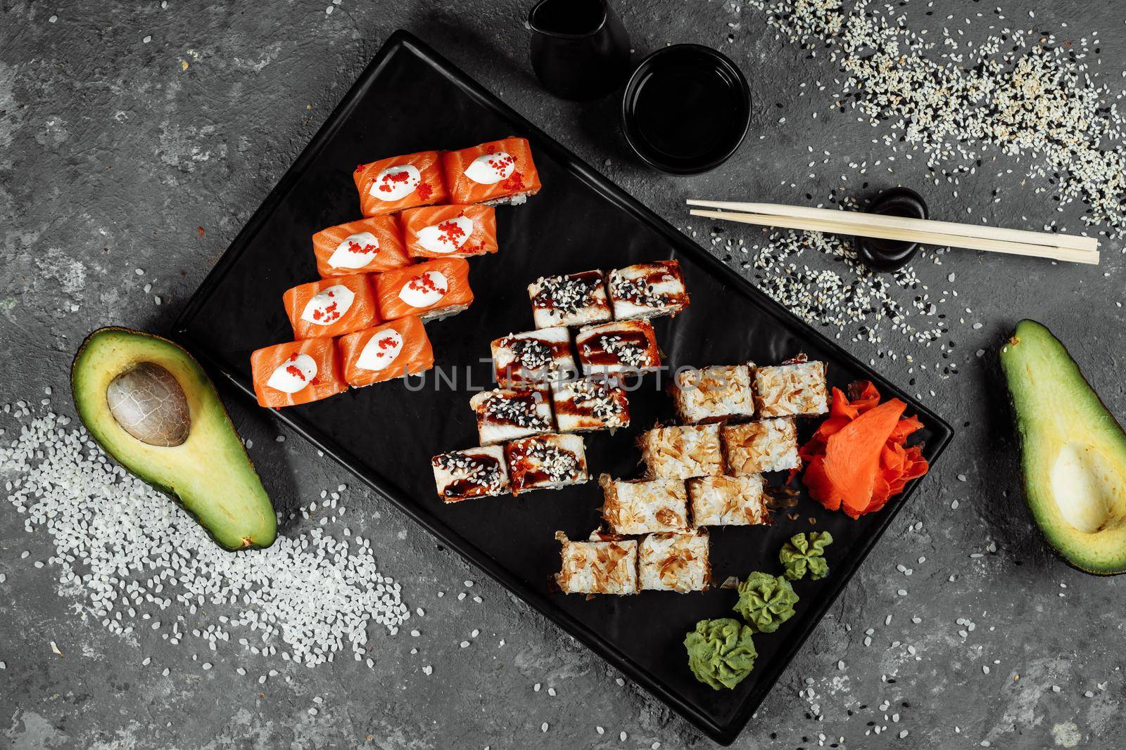 Sushi set with fresh ingredients on gray background. Sushi menu. Japanese food.