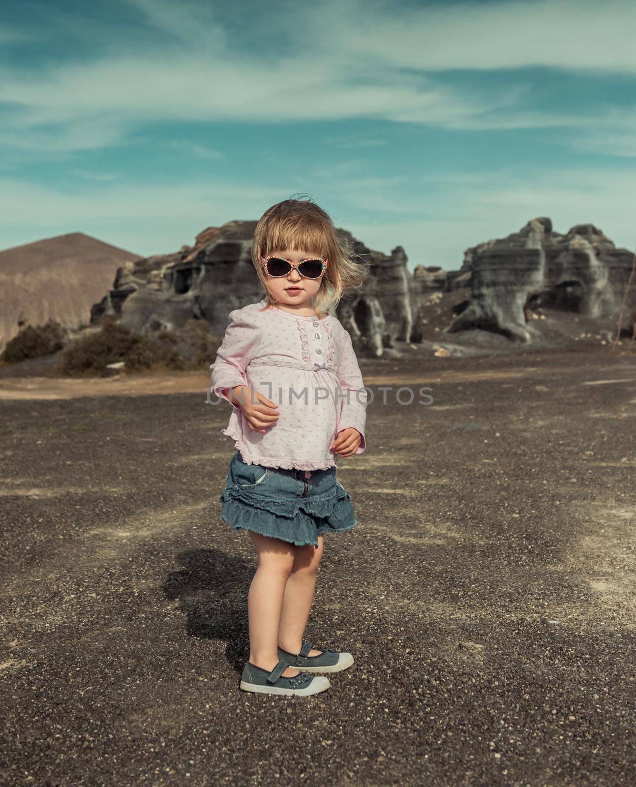 little cute girl on a warm spring day in the mountains