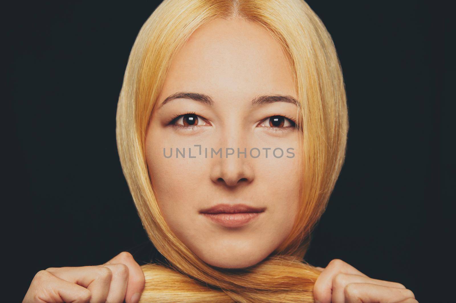 Portrait of beautiful blonde young woman, looking at camera