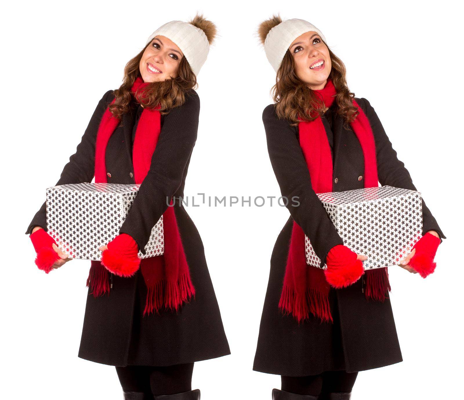 Young and beautiful woman holding a nice Christmas present. Isolated on white.
