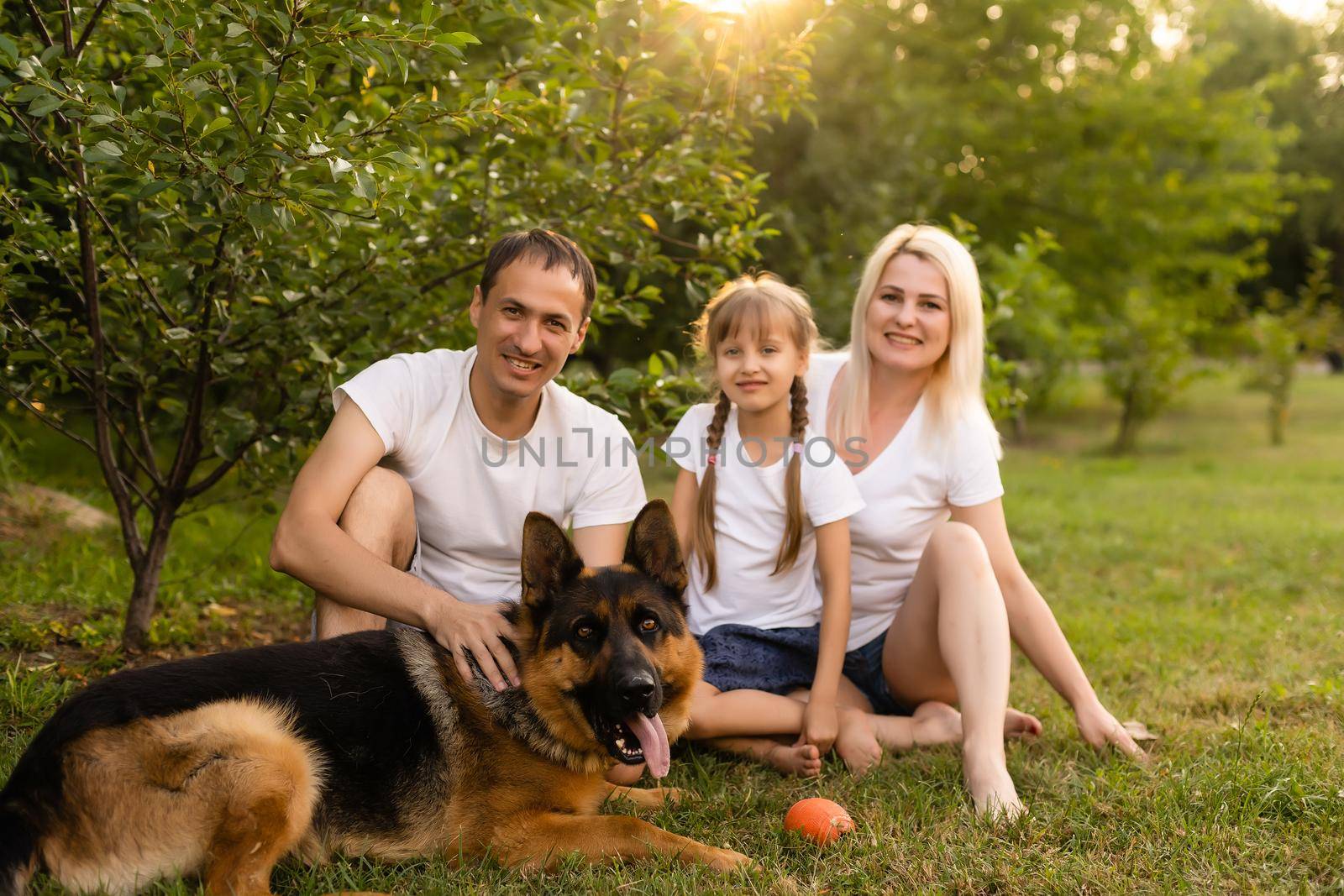 Portrait of cheerful extended family sitting in the park