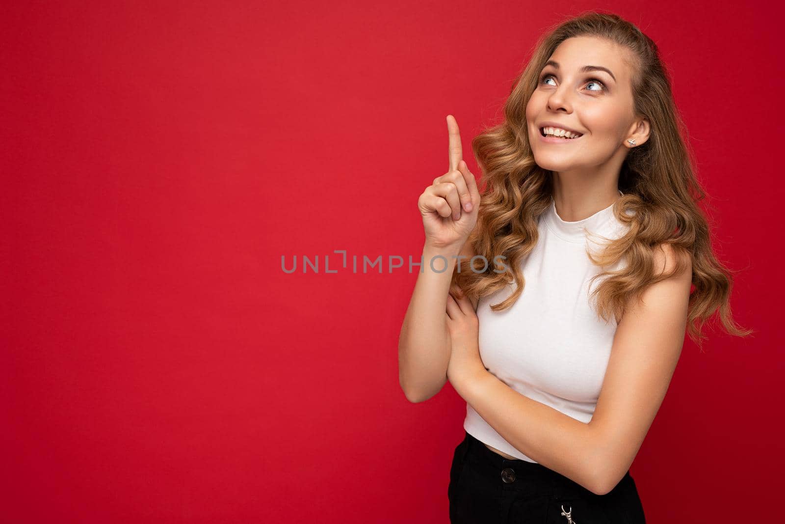 Photo of young positive happy smiling beautiful woman with sincere emotions wearing stylish clothes isolated over background with copy space and having an idea by TRMK