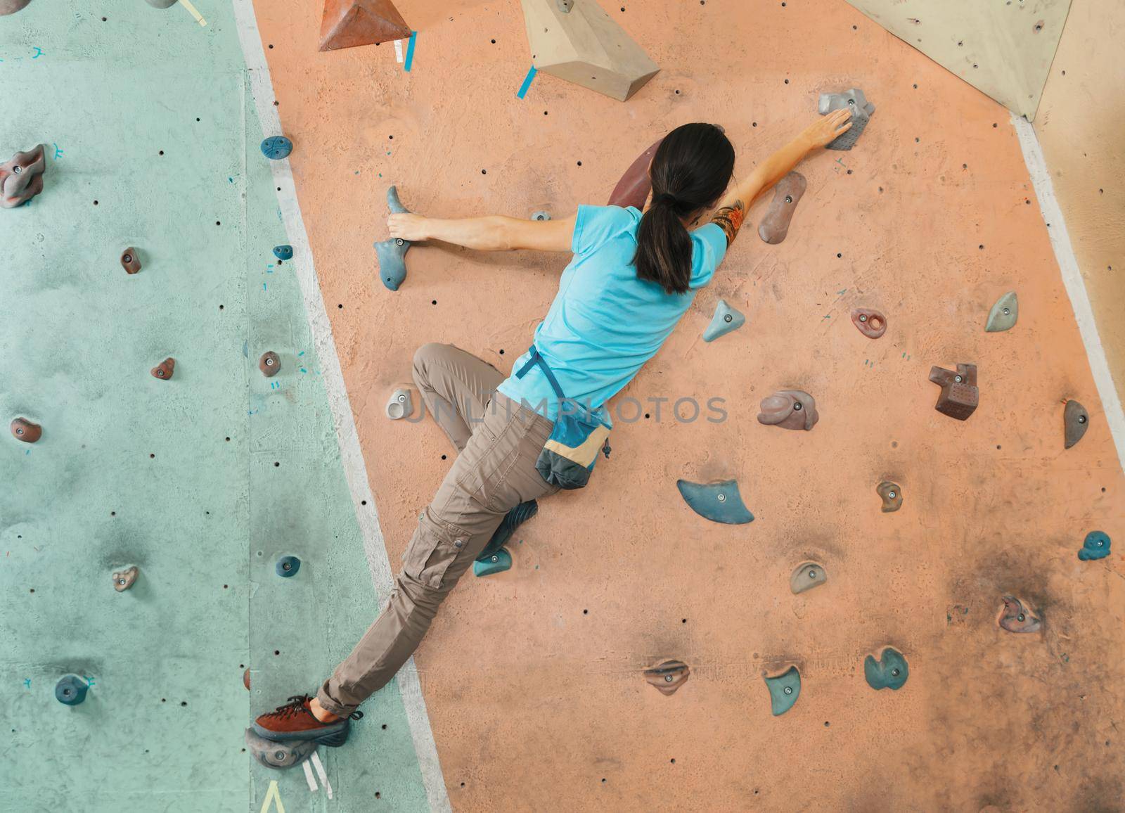 Free climber woman training indoor by alexAleksei
