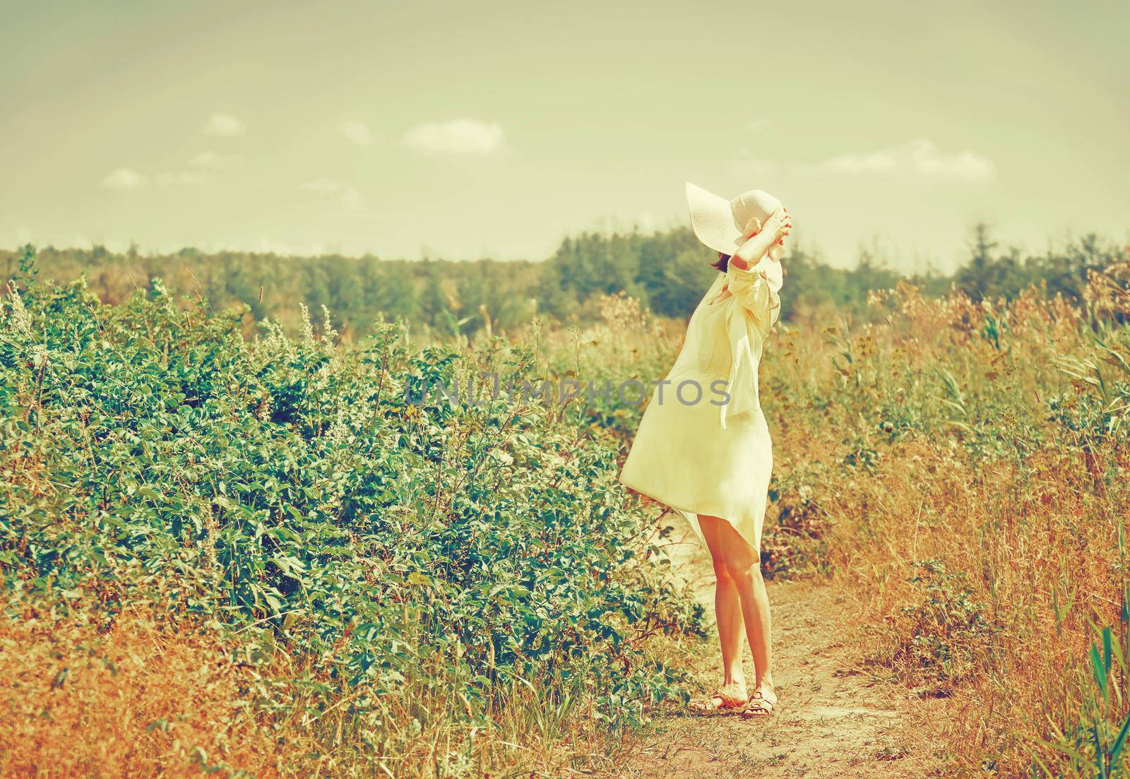 Fashionable girl walking in summer park by alexAleksei