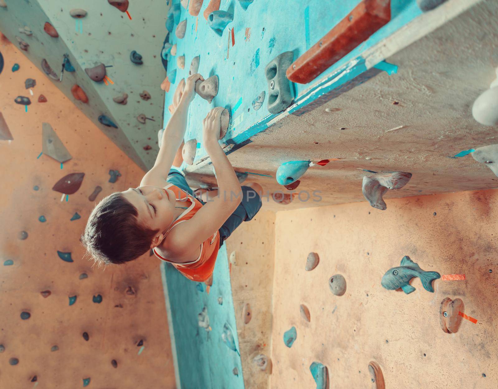 Boy climbing in gym by alexAleksei