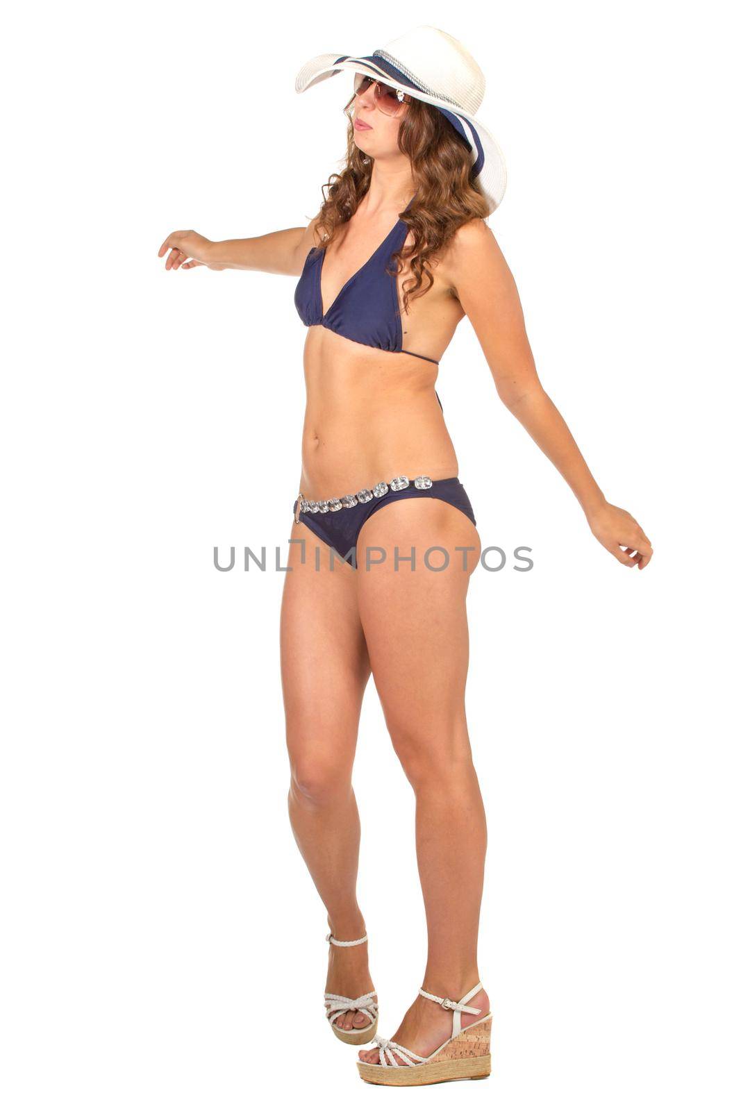 Pretty girl posing in bikini summer hat and sunglasses looking up