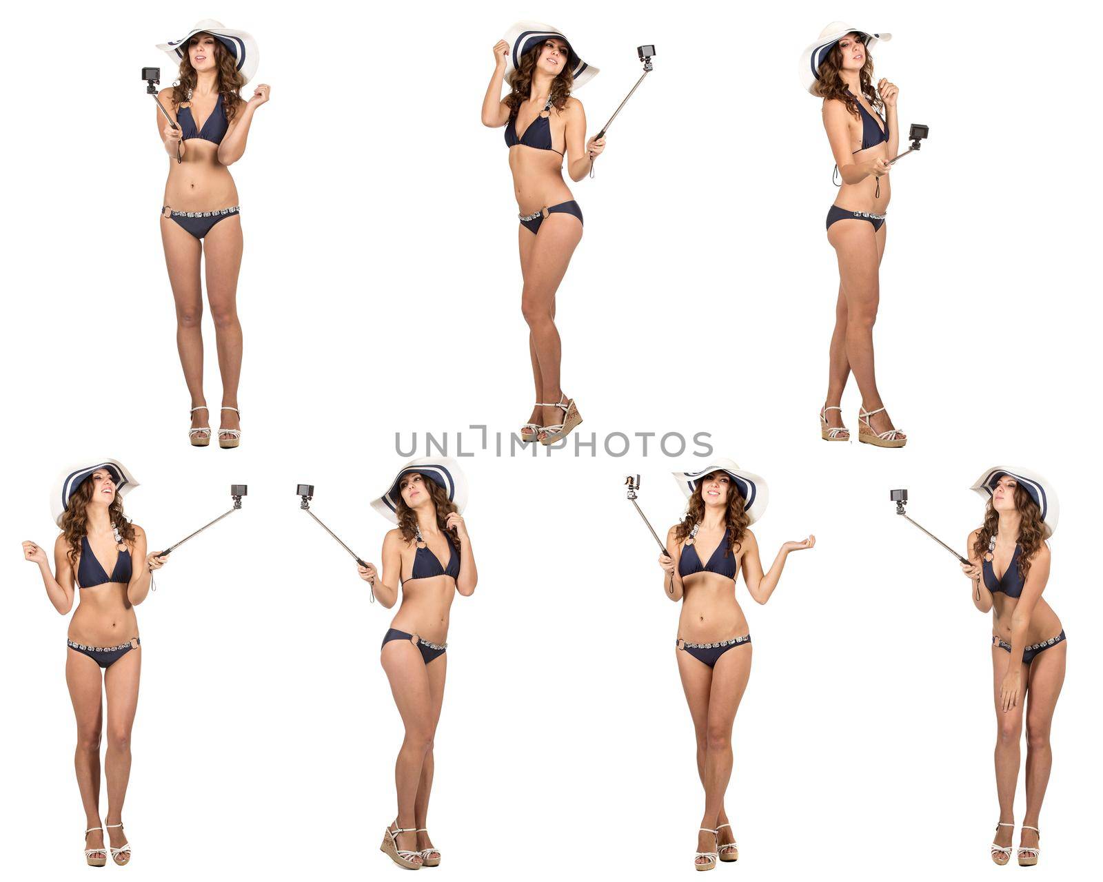 Travel concept. Studio portrait of pretty young woman taking selfie with action camera. Isolated on white.