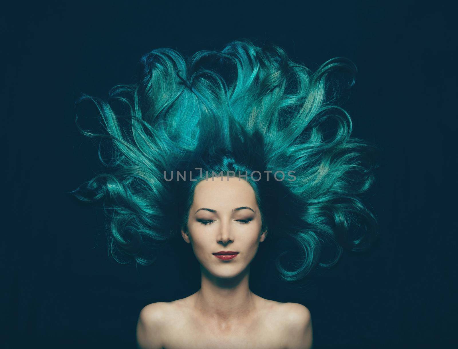 Portrait of smiling beautiful girl with closed eyes and long hair of turquoise color, top view. Image of mermaid
