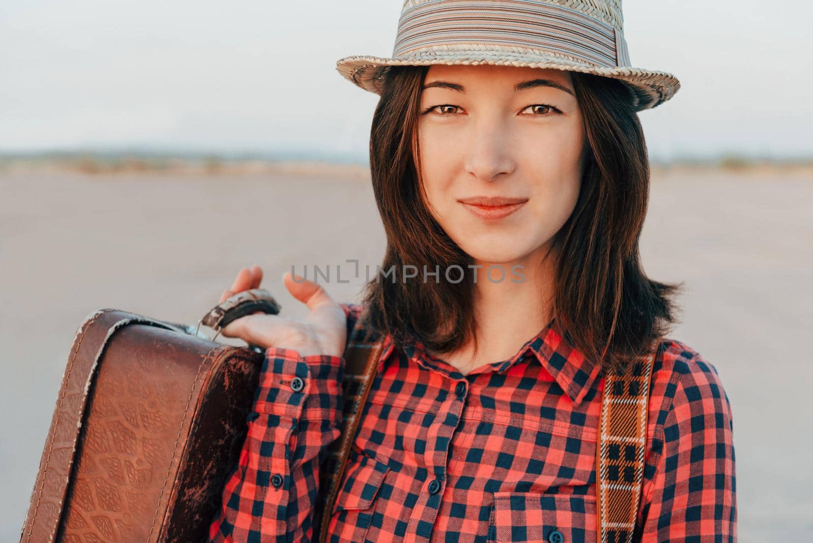 Portrait of young woman with suitcase by alexAleksei