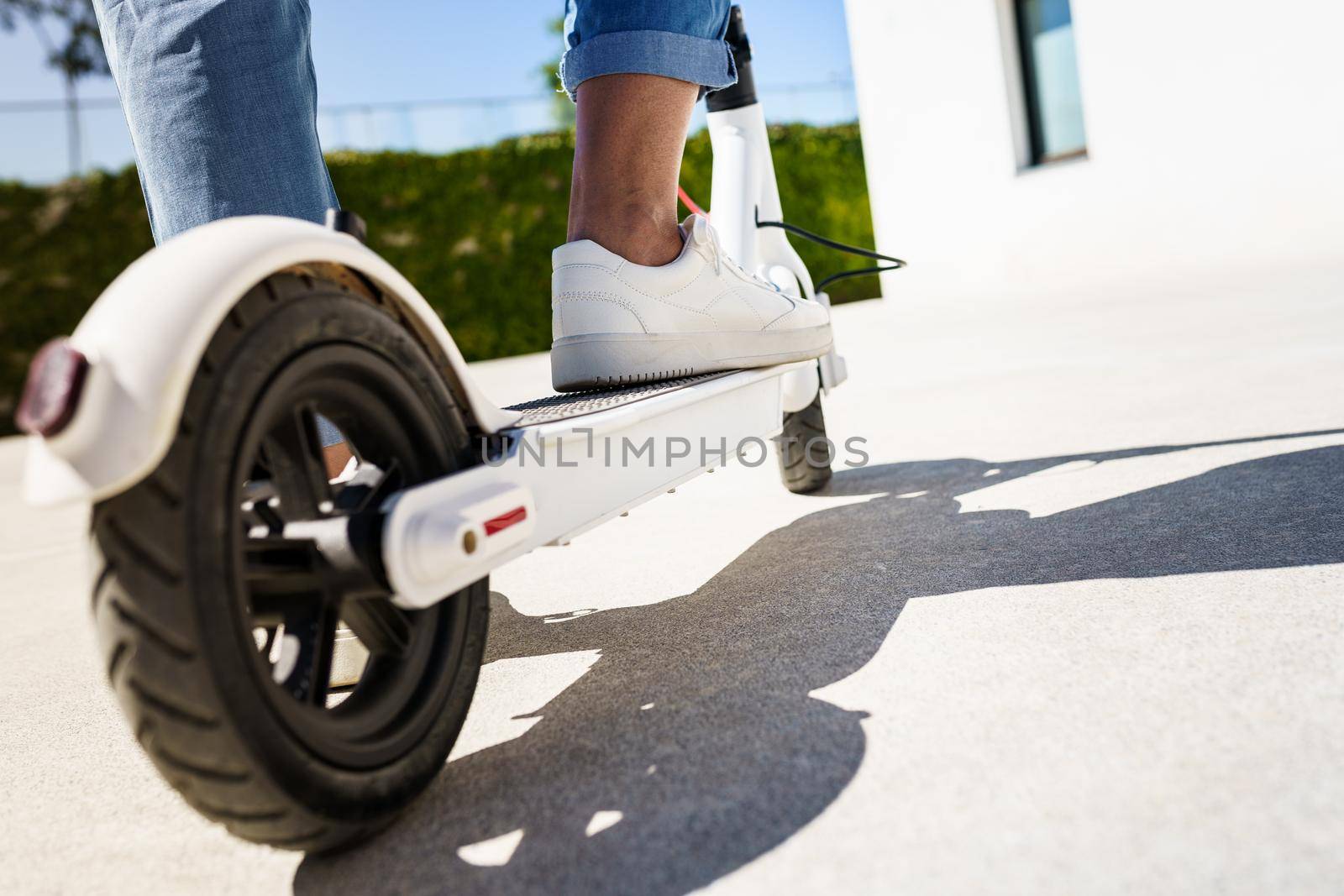 Woman circulating in the city with an electric scooter by javiindy