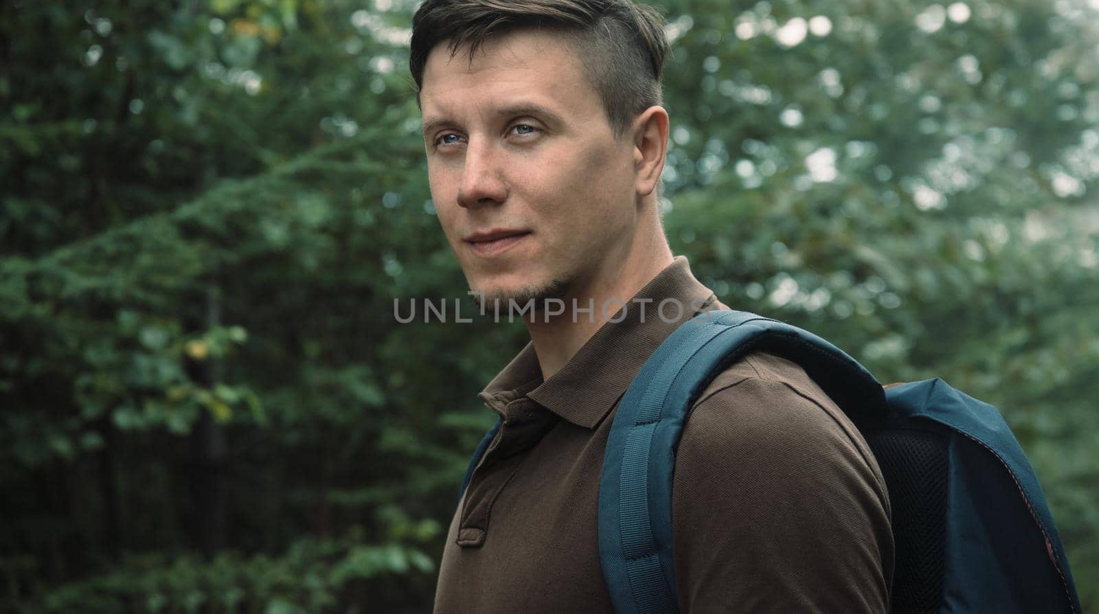 Portrait of hiker young man in summer forest
