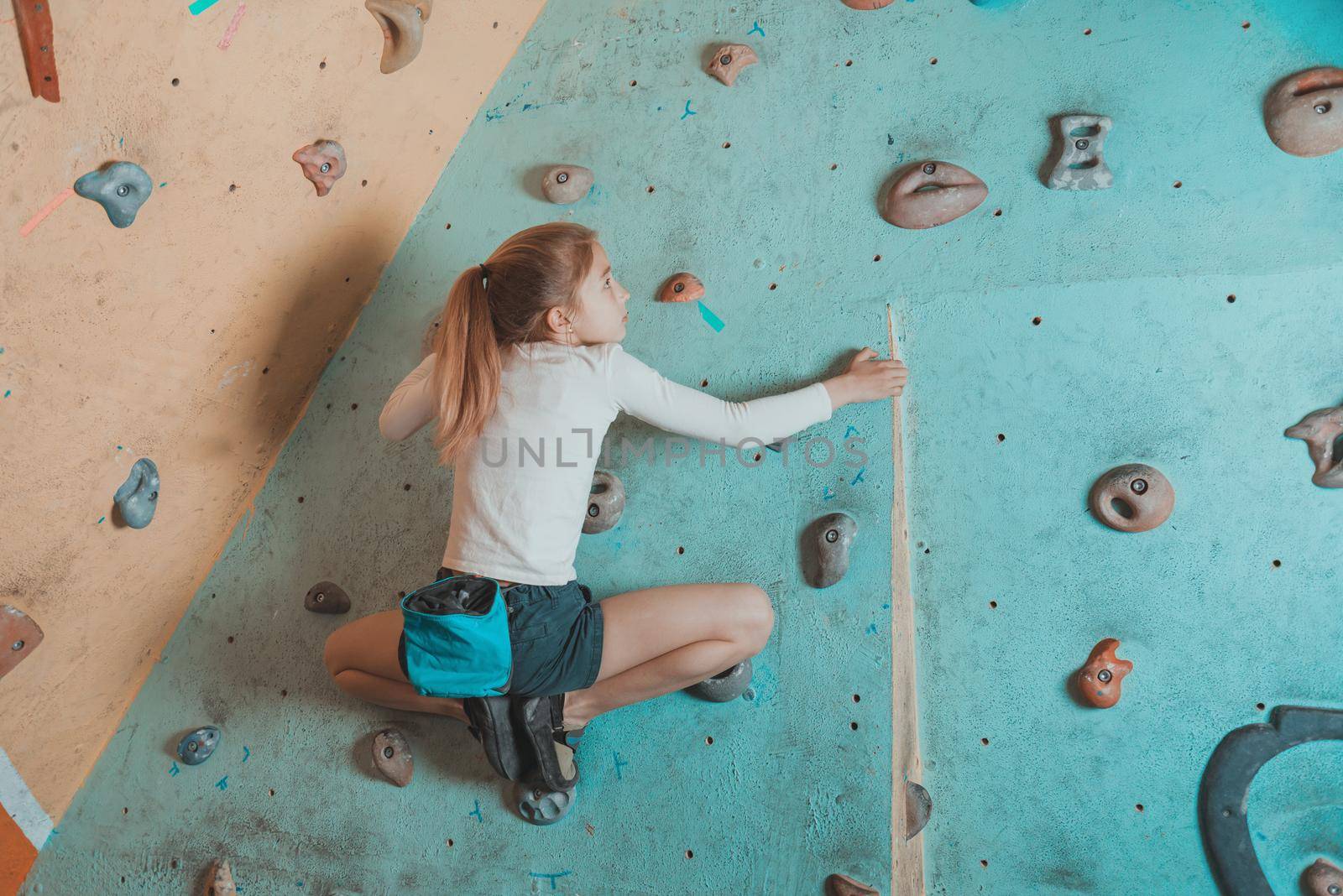 Little girl climbing indoor by alexAleksei