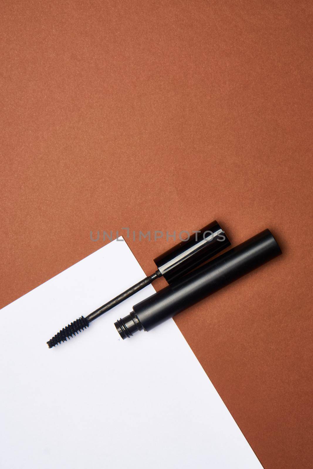 makeup brushes mascara accessories glamor brown background. High quality photo