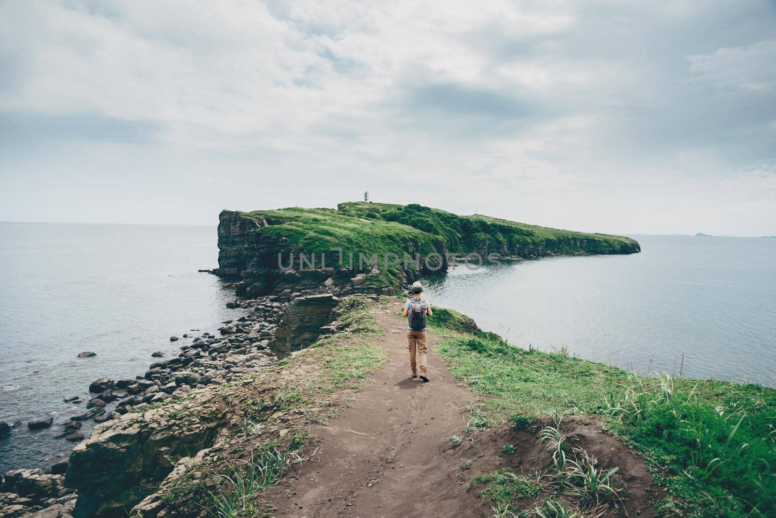 Traveler girl walking on island in summer by alexAleksei