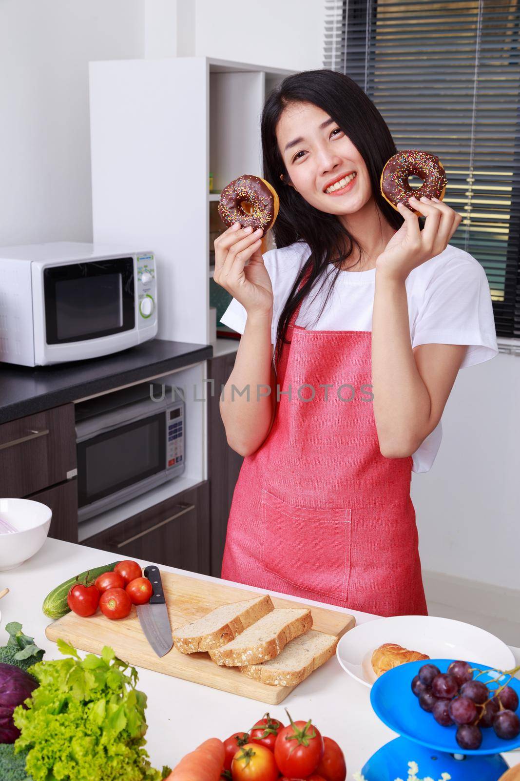 woman with a chocolate donut in hand, kitchen room by geargodz