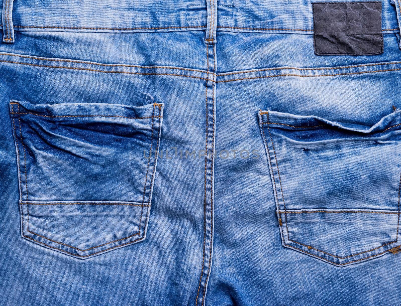 rear paft of blue male jeans with pockets, closeup