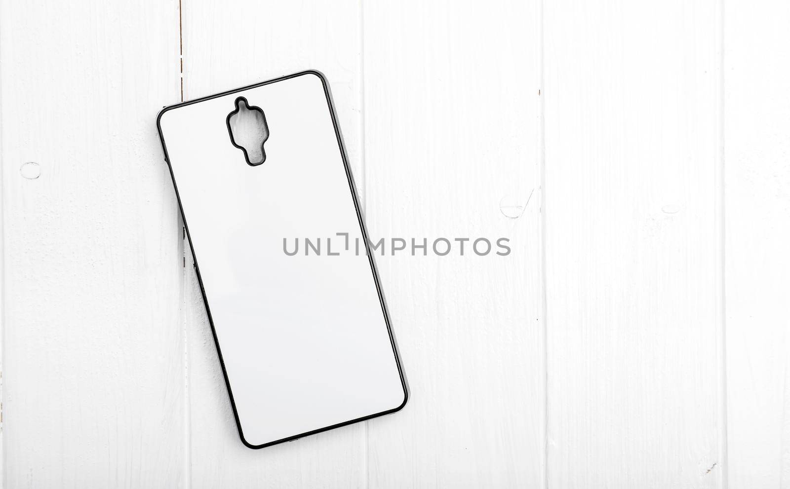 white phone case for prnting lying on white table