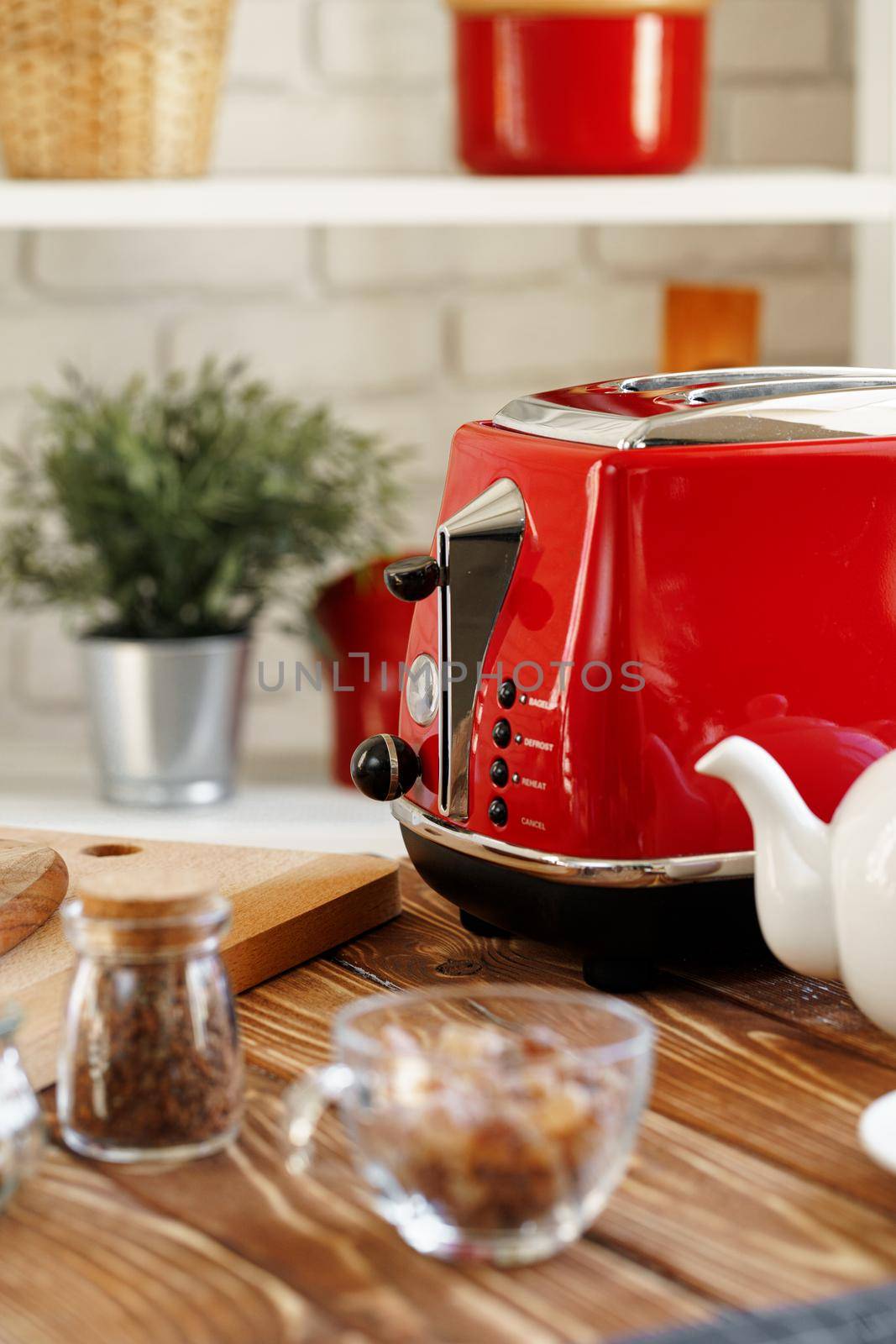 Ceramic teapot and toaster, kitchen table counter close up