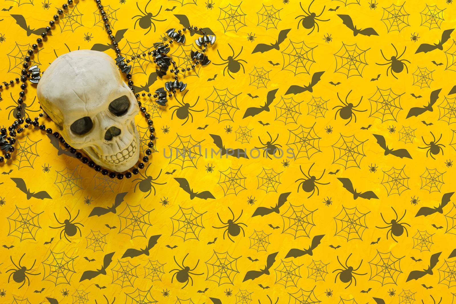 Scary skeleton decoration on the table for Halloween, copy space