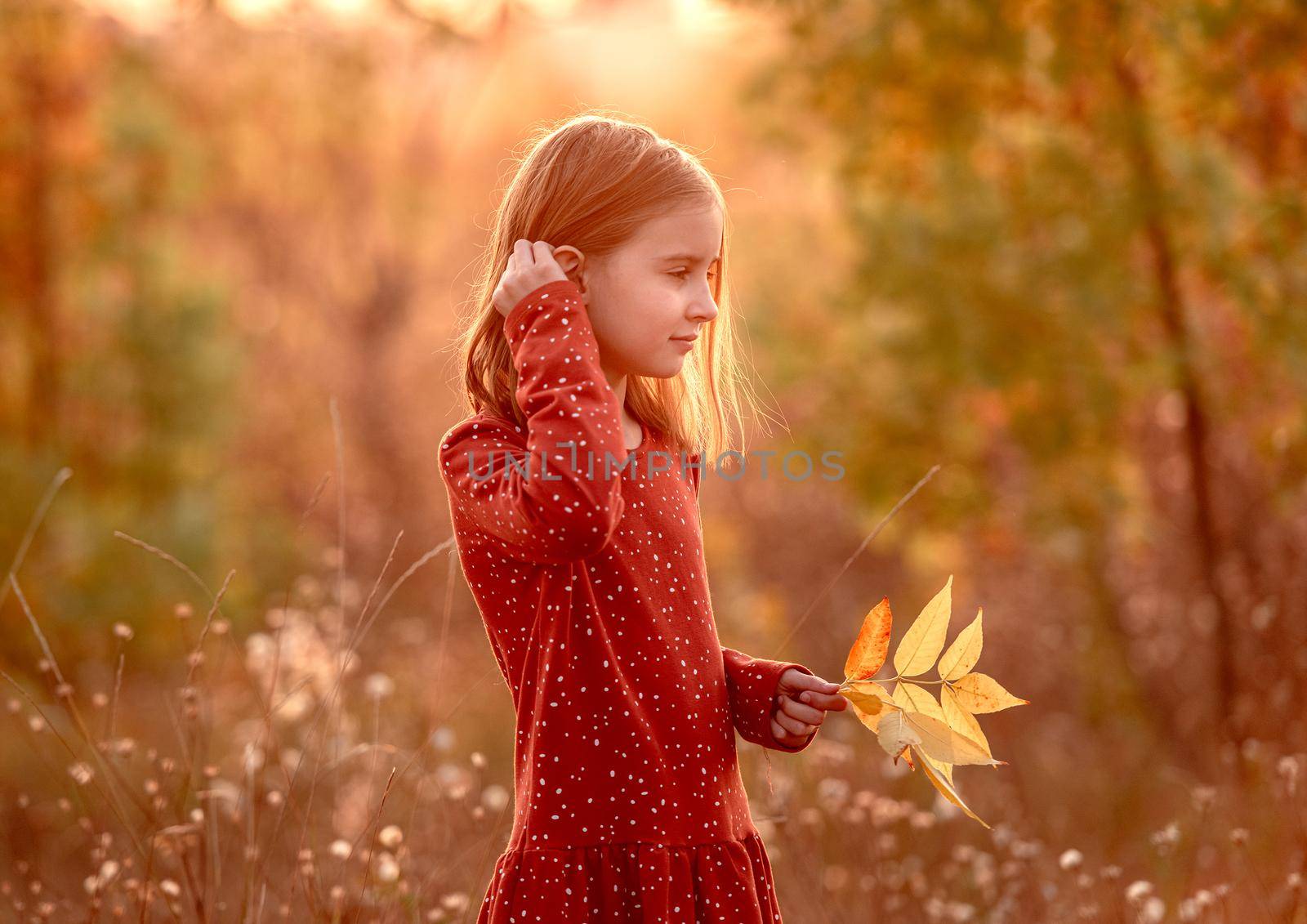 Smiling little girl with autumn leaves by tan4ikk1