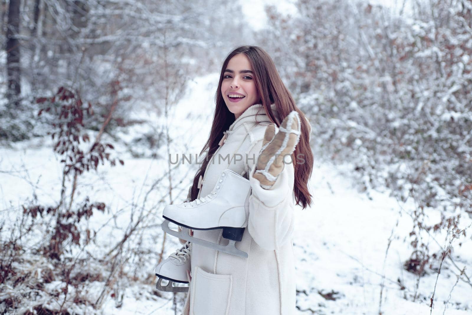Winter woman. Laughing Girl Outdoors. Model wearing stylish sweater and gloves. Portrait of a young woman in snow trying to warm herself. Winter woman. by Tverdokhlib