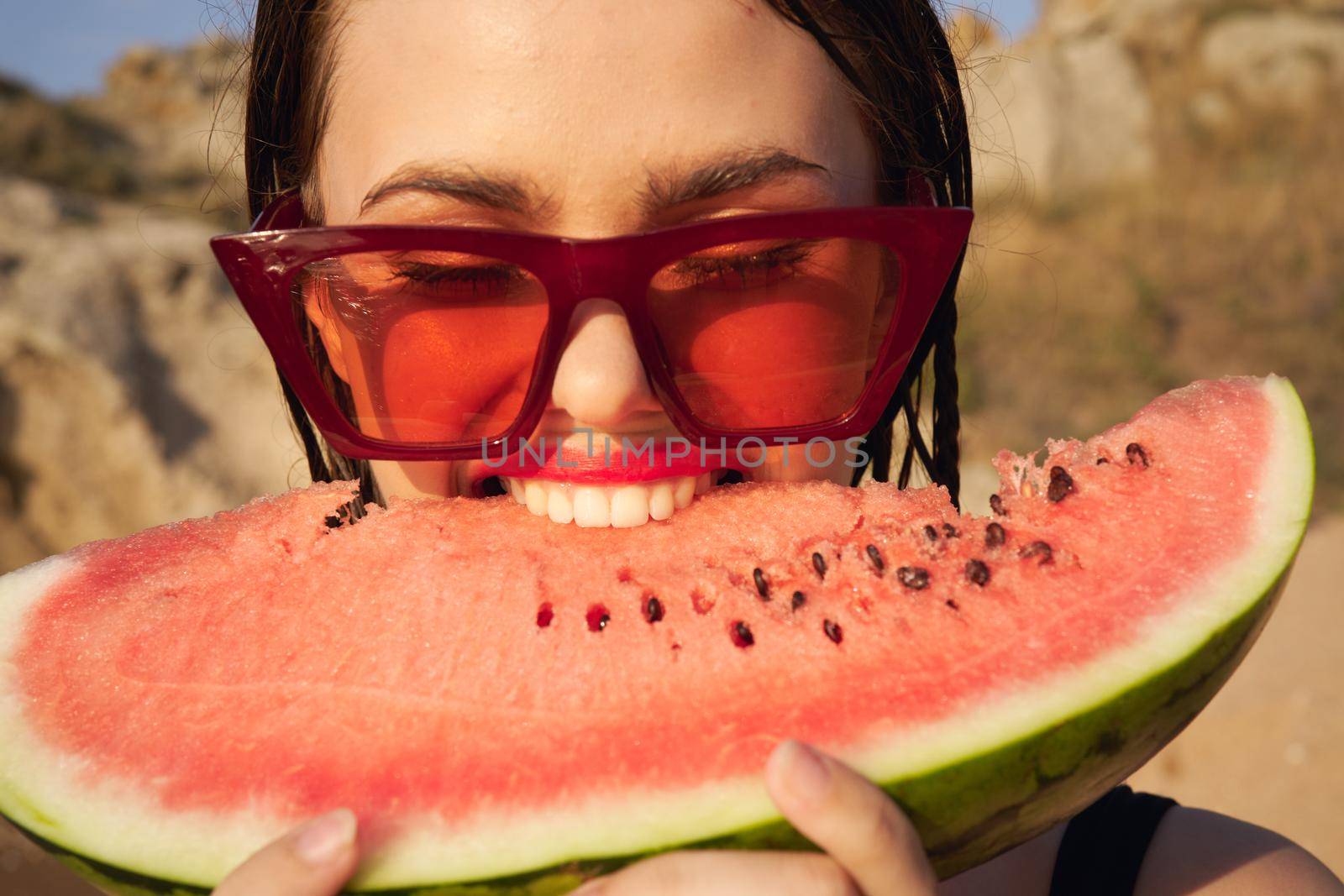 Cheerful woman eating watermelon nature summer vacation. High quality photo