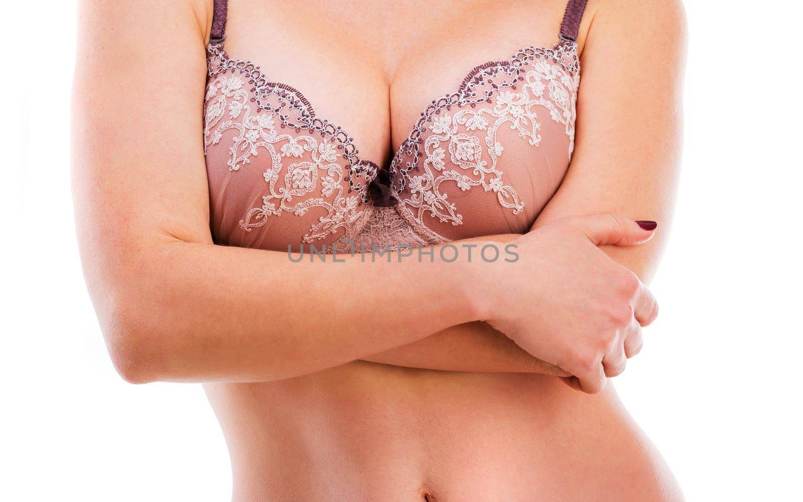 Female in lingerie crossing her arms on her chest, isolated on a white background