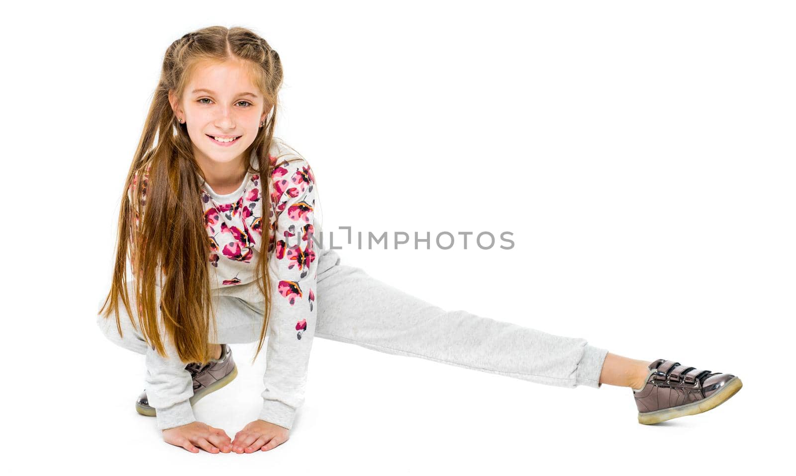 Cute little girl do stretching isolated on white abckground by GekaSkr