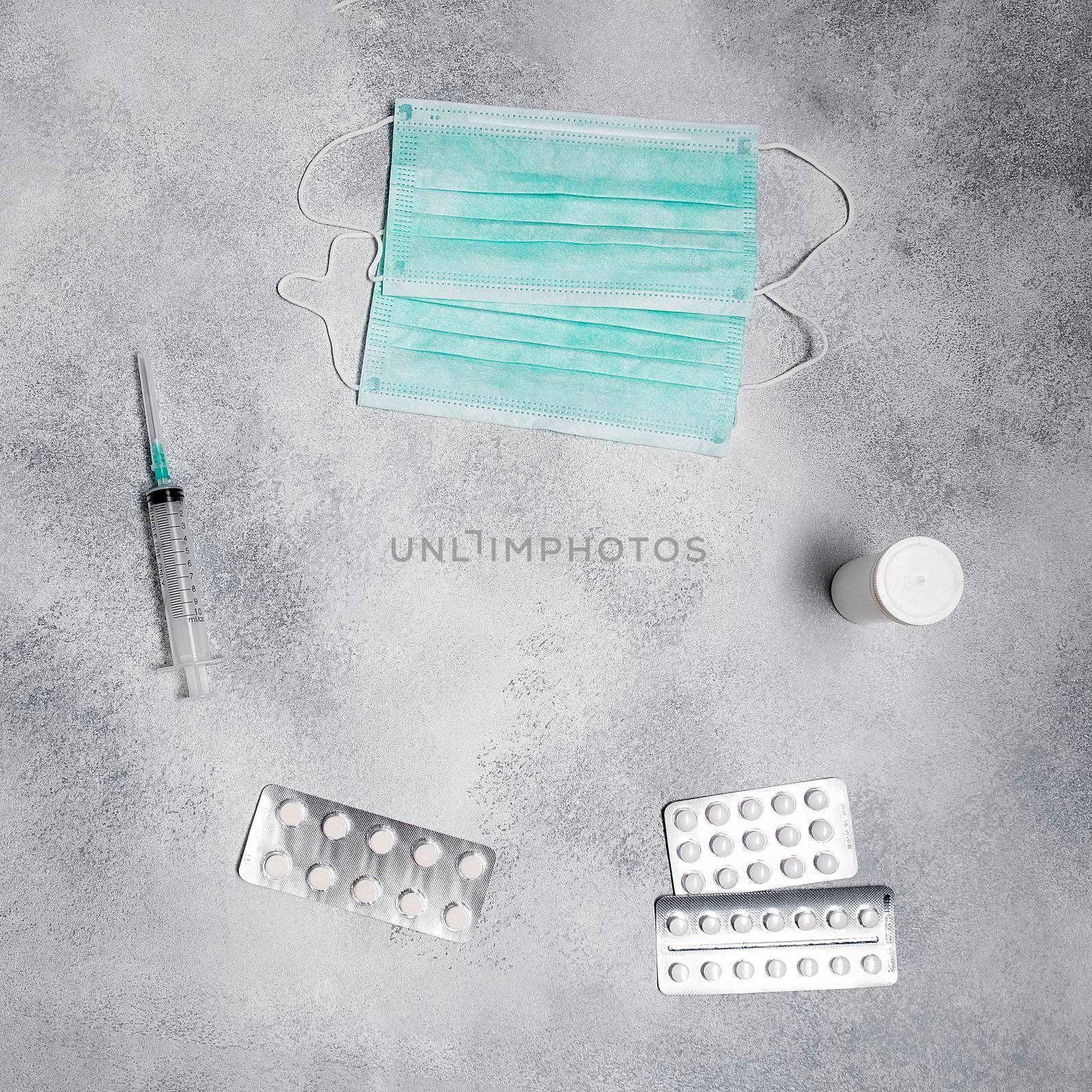 face masks, syringe, medicine pills, vial flatlay. prescription drug for treatment medication top view. Pharmaceutical medicament, cure in container. Injection of covid-19, 2019-nCoV vaccine flat lay