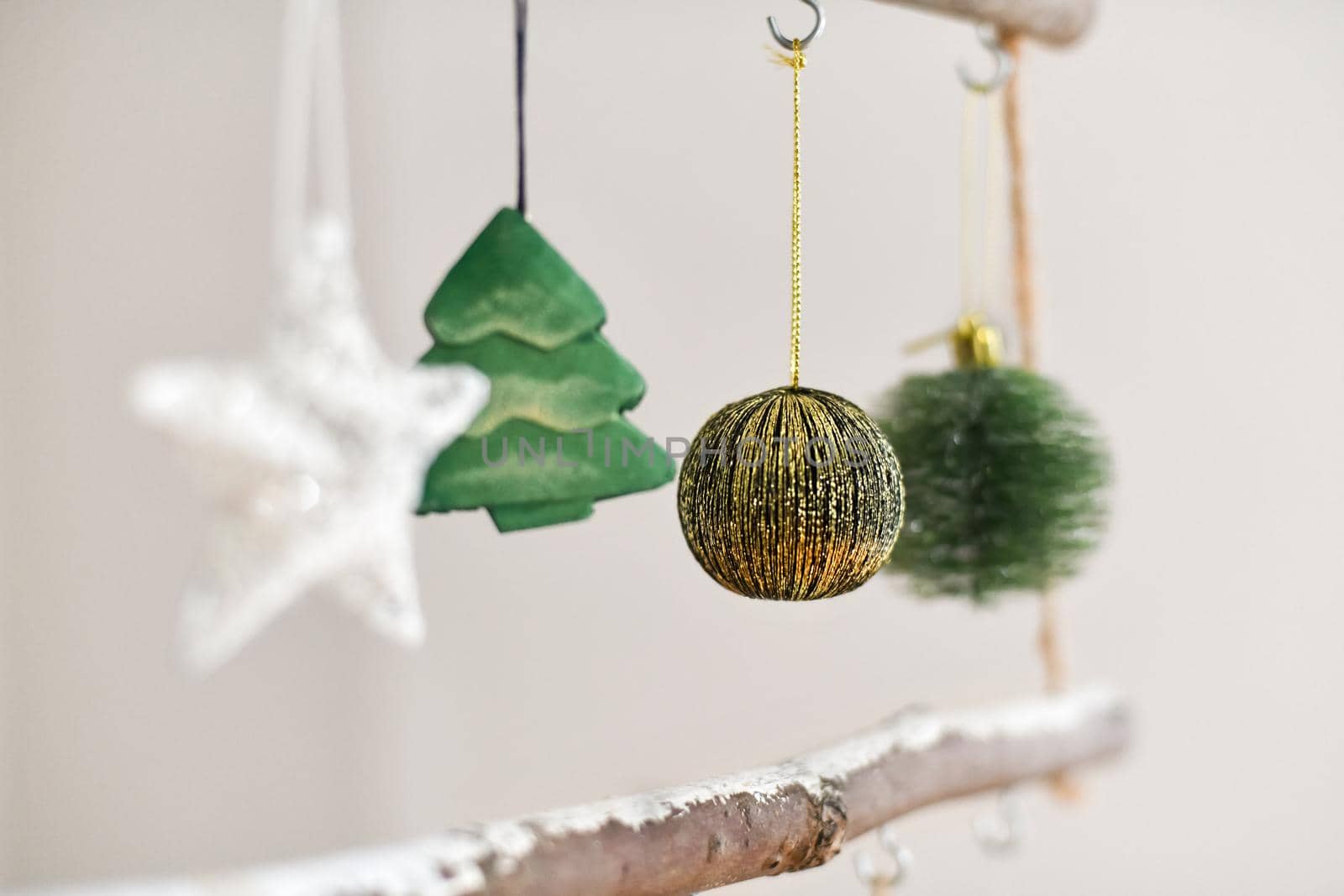 Handmade wooden Christmas tree with toys hanging on the wall