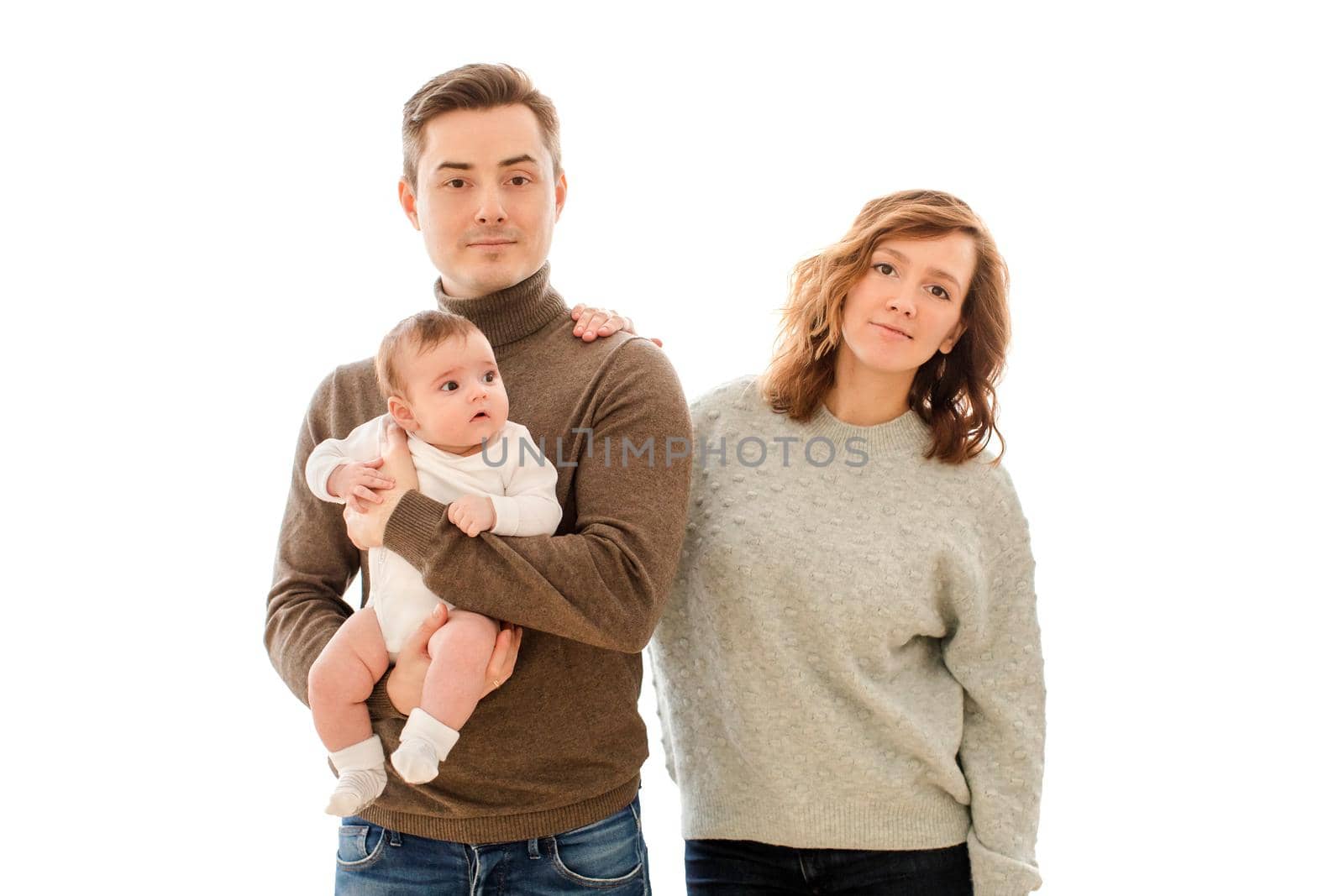 Portrait of young family with little child isolated on white.
