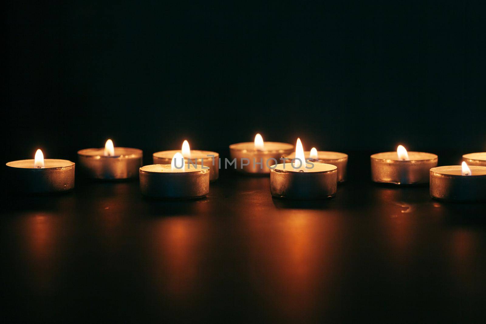 the light of the candle illuminates the darkness
