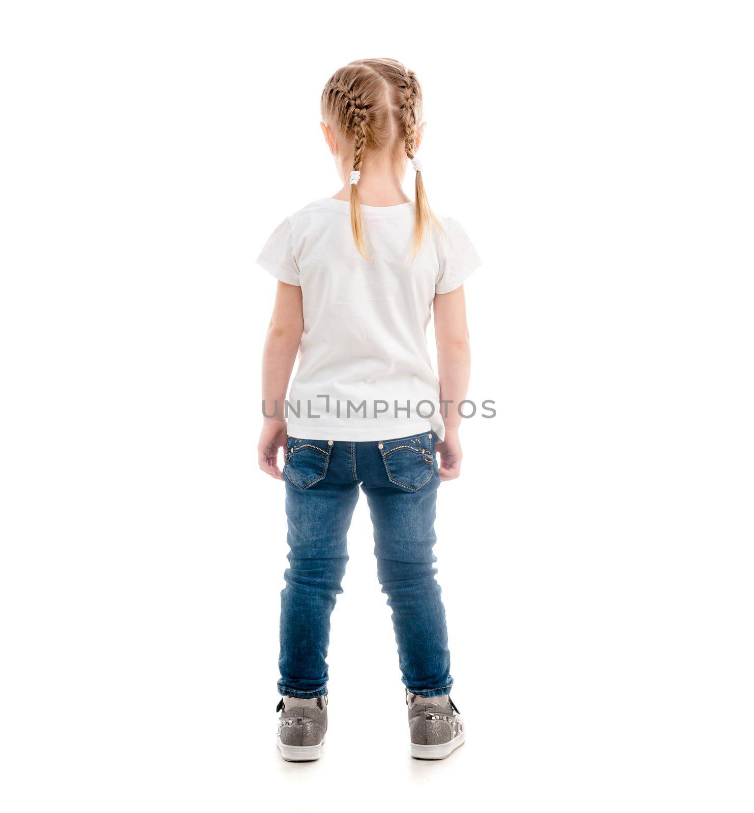 Small child standing with her back turned, wearing white t-shirt and blue jeans, isolated