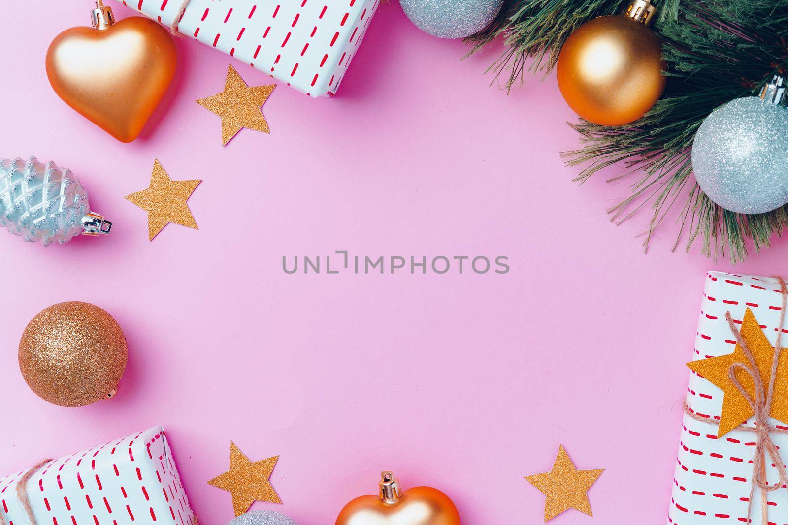 Christmas festive decorations with copy space on pink background, top view