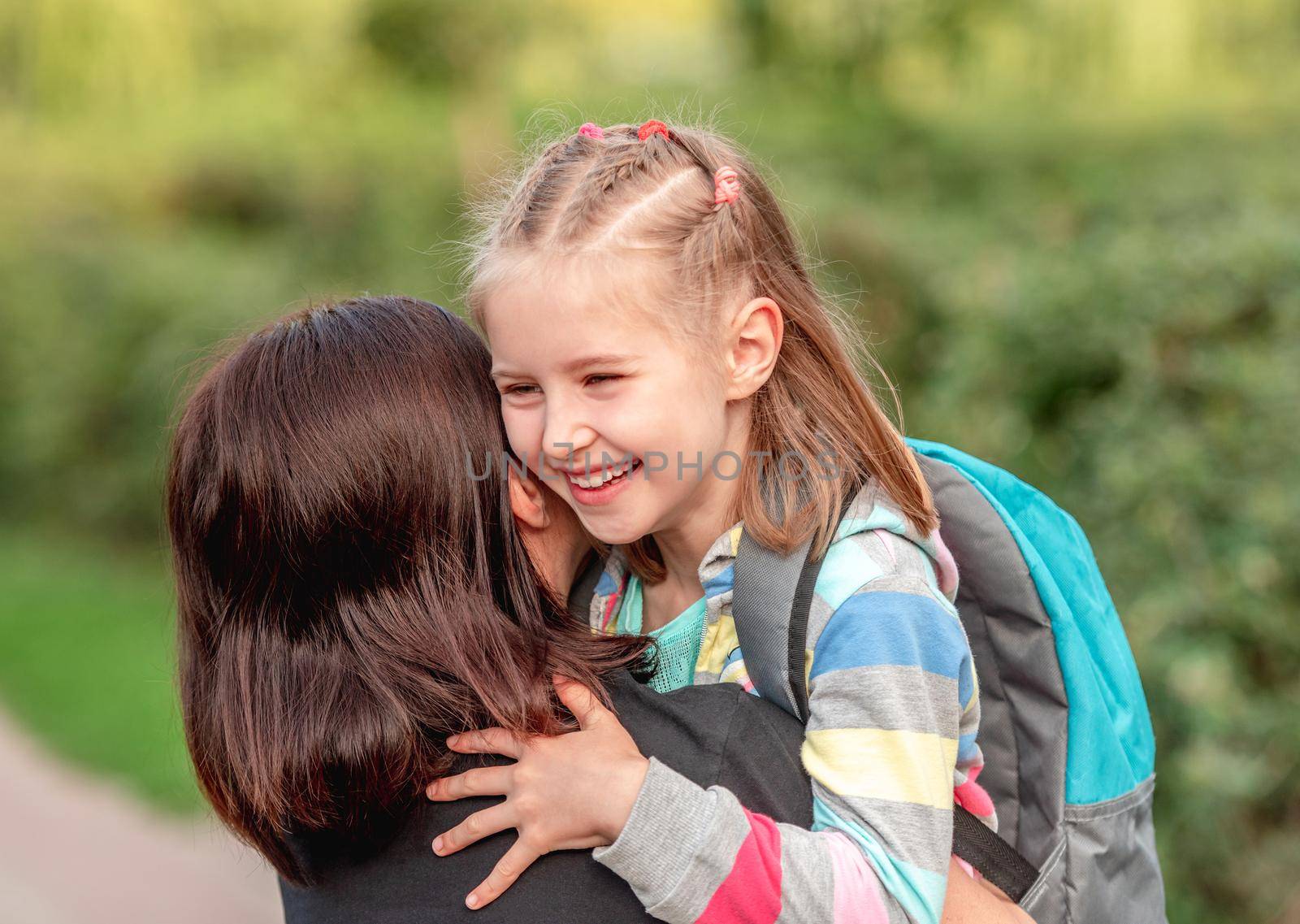 School girl hugging mother after classes by tan4ikk1