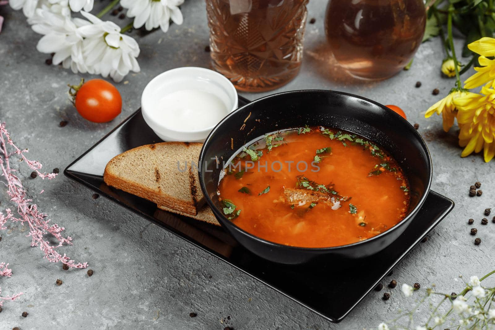 Traditional Ukrainian Russian borscht with white beans on the black bowl. Flat lay. Top view.