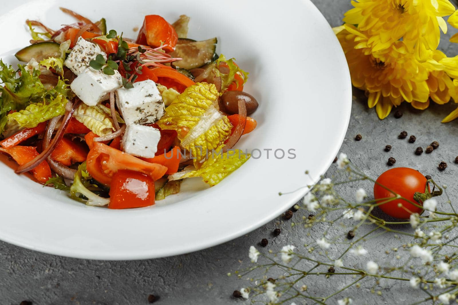 Greek salad with fresh vegetables, feta cheese and black olives.