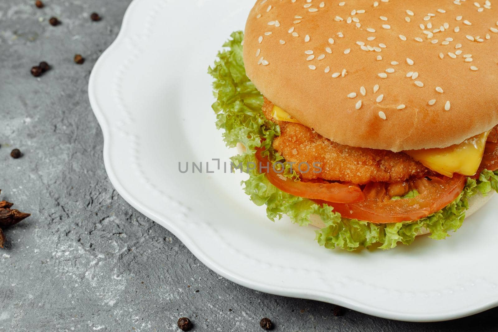 hamburger with fries and salad on the plate.